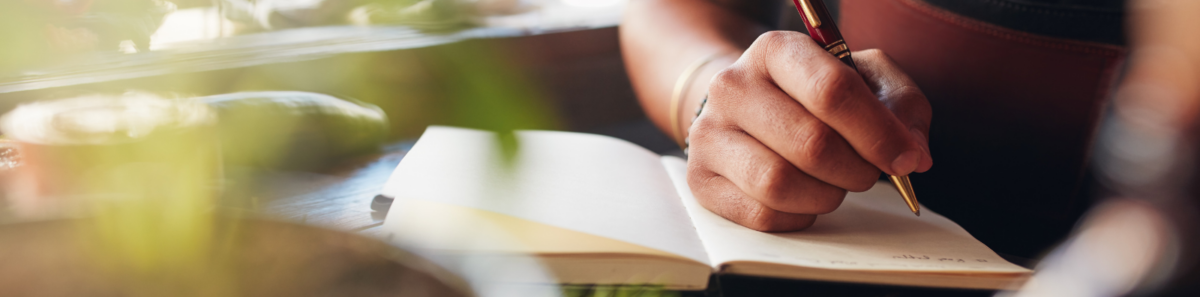 Person writing down ideas in a notebook